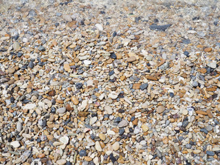 Pebble stones and sea wave on summer beach