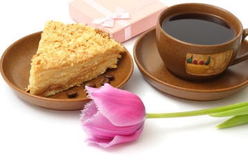Pink tulip flower with coffee and cake isolated on white