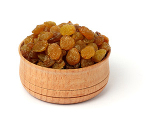 Organic dried Raisins in wood plate isolated on white background