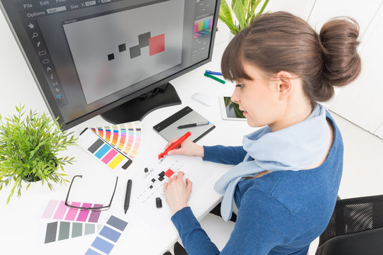 Graphic designer at work. Color samples.