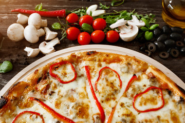 Homemade hot pizza with ingredients.