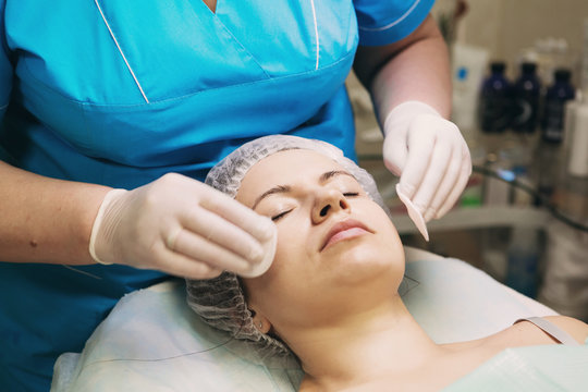 Young woman In Spa Salon With Facial Mask