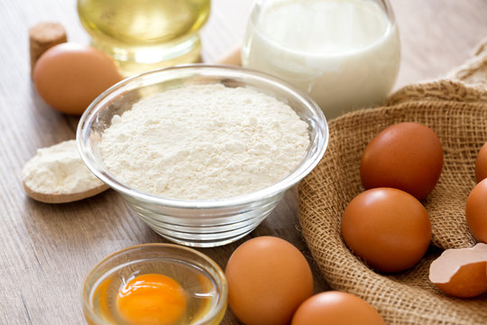 Eggs, flour and milk background.