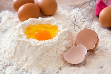 Baking ingredients -mixing egg and flour .