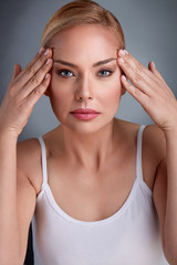 Fototapeta premium middle aged women looking her face skin