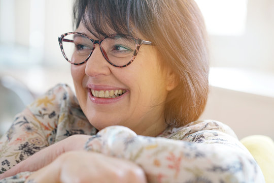 Portrait of cheerful mature woman with eyeglasses