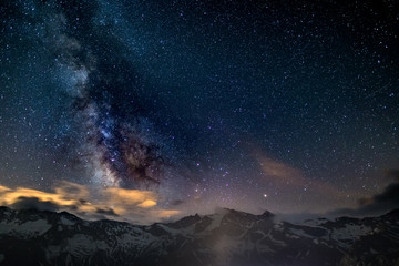 The colorful glowing core of the Milky Way and the starry sky captured at high altitude in...