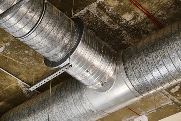 large ventilation pipes on the ceiling