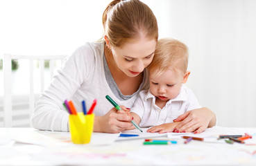 Mother with baby son with colored pencils