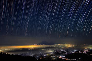 Foto op Aluminium Night island of Java from the slope of Merapi volcano and star track © yurybirukov