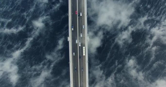 Amazing urban landscape. View of the bridge in the fog top down. Nadir. Aerial View.