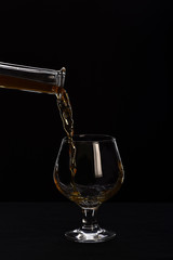 glass, carafe with cognac or whiskey isolated on black background