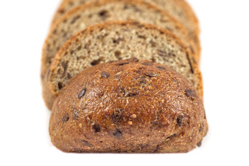 Dark rye bread with seeds on white background