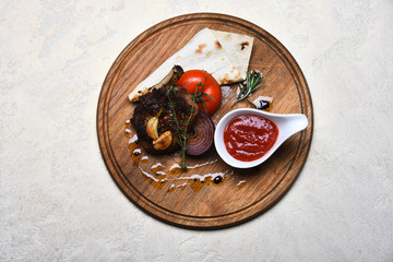 fried rib meat, pita bread, tomato, onion, garlic, ketchup, thyme