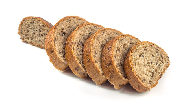 Dark rye bread with seeds on white background