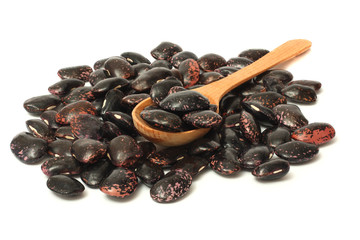 black kidney beans with wood spoon isolated on white background
