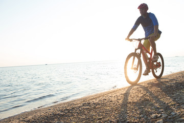 Man riding a mountain bike on the beach