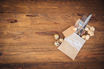 Place table settings over wooden background 