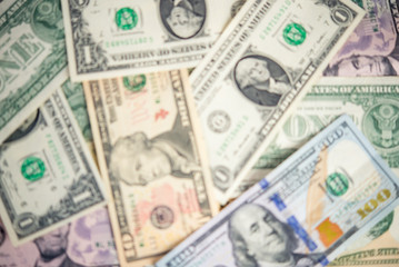 Background of banknotes, dollar bills in defocusing