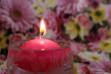 Obraz na płótnie Canvas Floating candle on a floral spring background