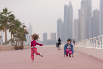 mother and cute little girl on the promenade