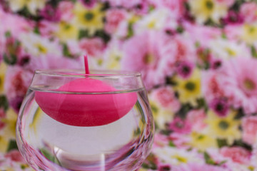 Floating candle on a floral spring background