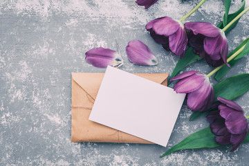 Flat lay workspace. Wedding invitation cards, craft envelopes, pink and red roses and green leaves...