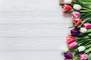Fresh tulips on a wooden background for Mother's Day.