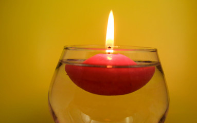 Floating candle on a bright colored background