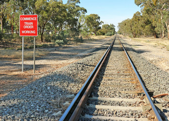 Obraz premium red and white Commence Train Order Working sign and railway tracks