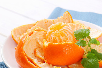 peeled tangerine arranged in peels