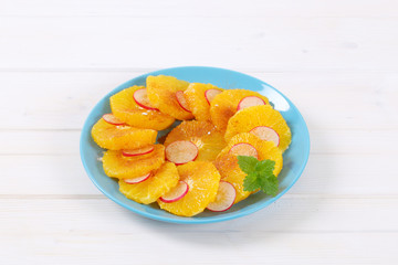 slices of orange, radish and cinnamon