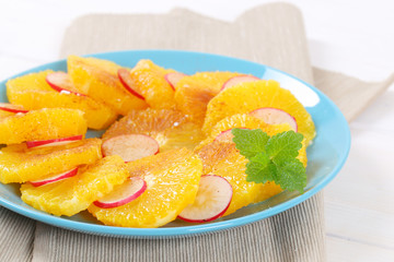 slices of orange, radish and cinnamon