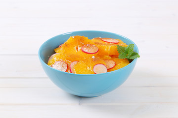 slices of orange, radish and cinnamon