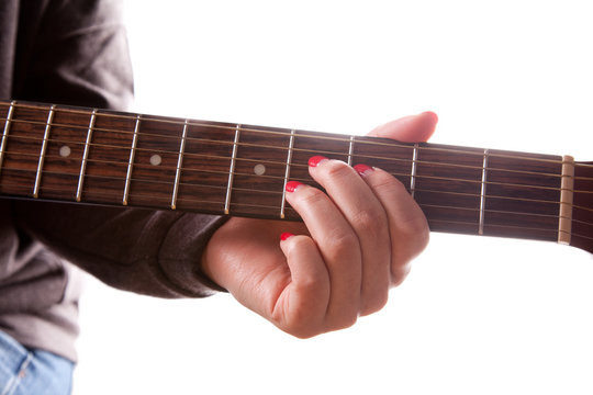 Close-up of woman playing acoustic guitar over the white background