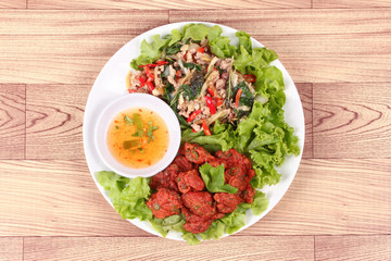 Fried spicy basil with minced pork and curried fish cake.