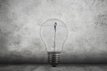 Businesswoman walking inside light bulb