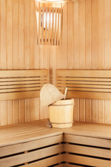 Obraz na płótnie Canvas Traditional wooden sauna for relaxation with bucket of water