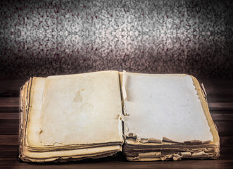 Open old book with blank pages for text on vintage wooden table