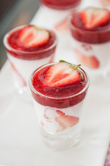 Close-up shot of dessert strawberry with whip cream.
