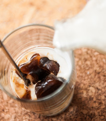 Ice made from coffee with milk. Shot of ice coffee.