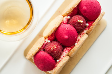Top view of vanilla raspberry cake with hot tea. 
