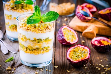 Yogurt parfait with granola, peach sauce and passion fruit with mint