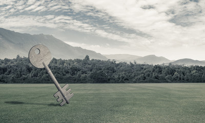 Conceptual background image of concrete key sign on green grass