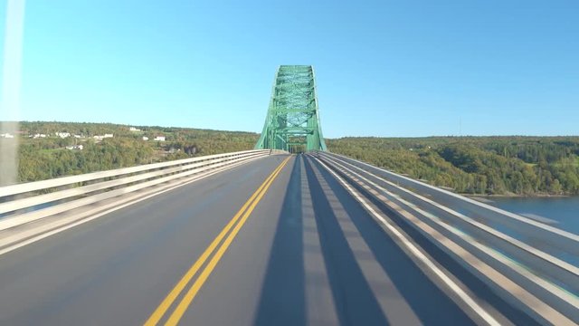 Close up crossing the seal island bridge driving along the trans-Canada highway on sunny day