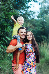 Fototapeta premium Happy smiling family in green summer park
