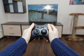 Hands of a woman holding a gamepad