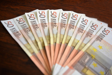 50 euro notes on wood background