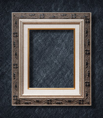 The antique frame on Dark grey black slate background or texture.
