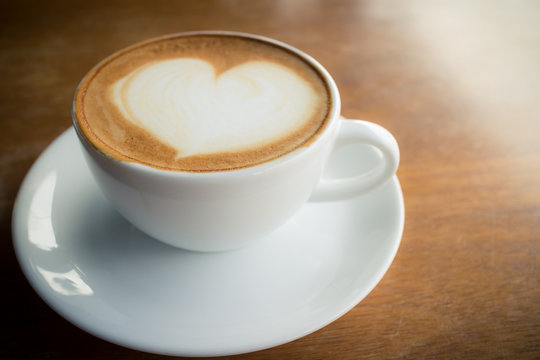 hot coffee with foam milk art like heart design